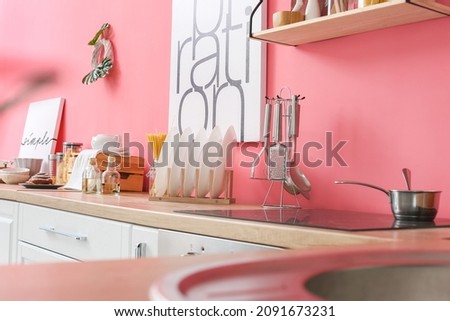 Utensils and plates on counter in kitchen