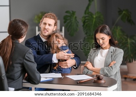 Young couple and their daughter visiting divorce lawyer in office Royalty-Free Stock Photo #2091684346