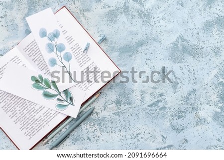 Book with bookmarks on color background