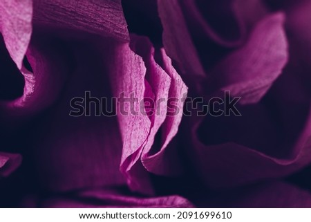 Fragment of a purple flower made of crepe paper. Soft selective focus