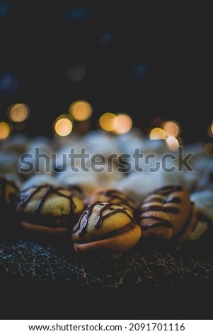 Moody picture of traditional Christmas bakeries on a place with bokeh effect and cozy atmosphere.