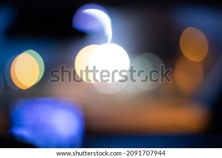 Bokeh from the night lights while driving. Abstract background.