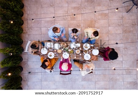 Storytelling footage of a multiethnic group of people dining on a rooftop. Family and friends make a reunion at home