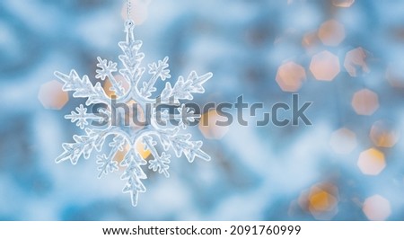 Winter snow background abstract bokeh. Snowflake Close-Up. Free space for text. Christmas, New Year.