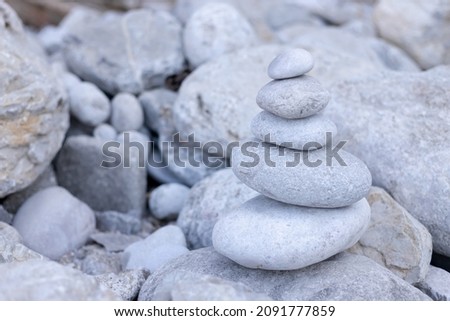 Stack balancing pebble stones pool with out of focus for background