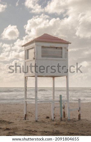 Lifeguard rescue pavilion by the sea. White tower on the seashore.