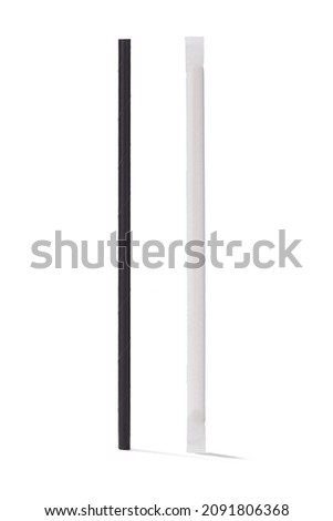 Detailed shot of a black paper cocktail straw and the same straw in the white individual packaging. The cocktail straws are isolated on the white background. Royalty-Free Stock Photo #2091806368