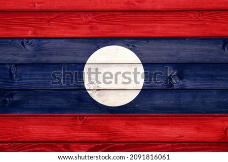 Flag of Laos on wooden surface 