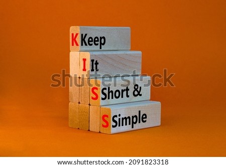 KISS keep it short and simple symbol. Concept words KISS keep it short and simple wooden blocks. Beautiful orange table, orange background. Business KISS keep it short and simple concept. Copy space.