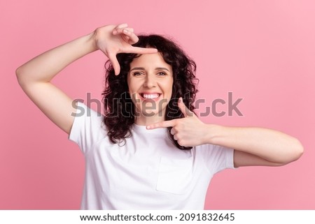 Photo of young excited lady show fingers border frame photographing isolated over pink color background
