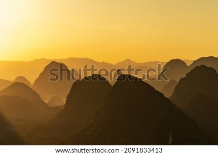 The sunset silhouette of Guilin yangshuo landscape in Guangxi, China is like Chinese landscape painting in the style of ink painting