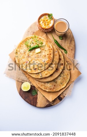 Paneer paratha is a popular North Indian flatbread made with whole wheat flour dough and stuffed with savory, spiced, grated paneer Royalty-Free Stock Photo #2091837448