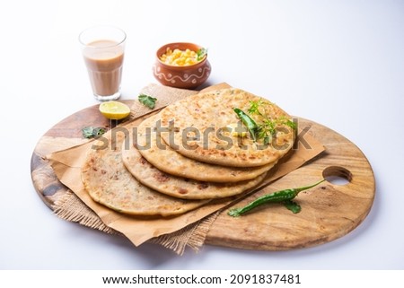 Paneer paratha is a popular North Indian flatbread made with whole wheat flour dough and stuffed with savory, spiced, grated paneer Royalty-Free Stock Photo #2091837481