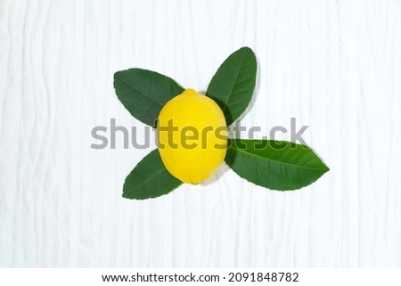 Lemon pile has leaves on white background close up, top view, bio food concept.
