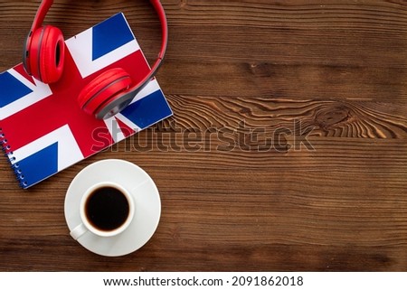 English courses concept. British flag on notebook and headphones