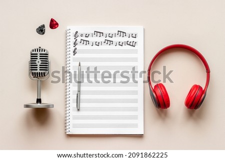 Composer table with music sheets and microphone, top view