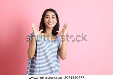 The Asian girl on the pink background.
