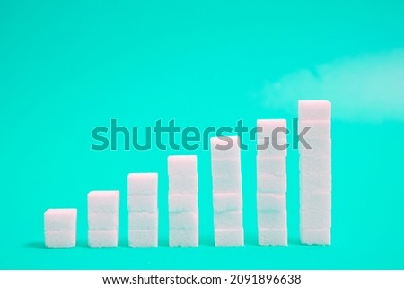 Financial chart made of sugar cubes with mint background. Sugar consumption growth rate world market concept.