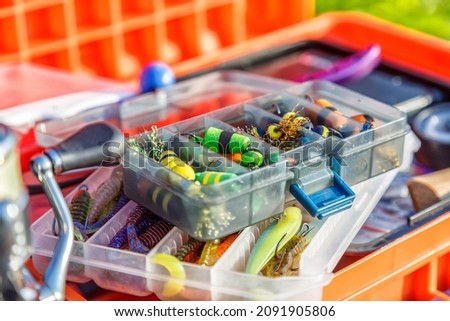 A large fisherman's tackle box fully stocked with lures and gear for fishing.fishing lures and accessories.Fishing tackle - fishing spinning. 