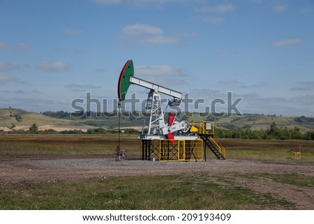 Oil pump. Oil industry equipment. Work of oil pump jack on a oil field.
