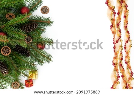 Branches of a Christmas tree and red and yellow gift boxes and balls on a white background. Christmas background with copyspace