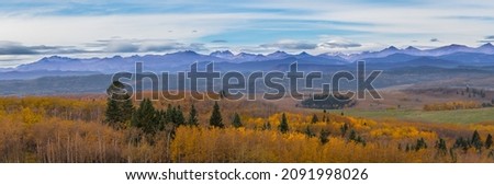 Canadian Rocky Mountain range landscape and panoramic autumn color background. Alberta prairie valley scenery and mountain lookout background. Beautiful panorama of the fall forest and mountains Royalty-Free Stock Photo #2091998026