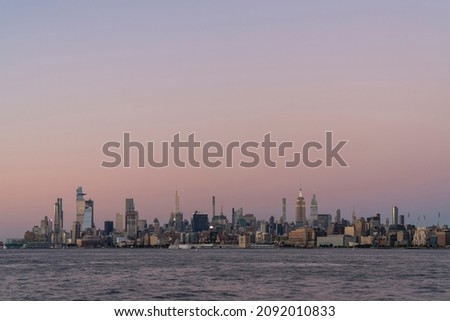 New York City skyline from New Jersey over the Hudson River with the skyscrapers of the Hudson Yards district at sunset. Manhattan, Midtown, NYC, USA. A vibrant business neighborhood