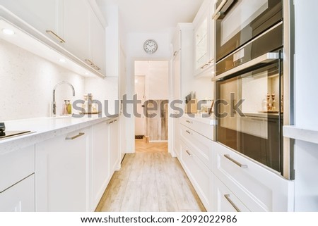 Long narrow kitchen with kitchen units on both sides Royalty-Free Stock Photo #2092022986