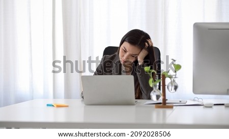 Beautiful asian business woman having a problem on her laptop computer. Unhappy or unsatisfied female worker. Royalty-Free Stock Photo #2092028506