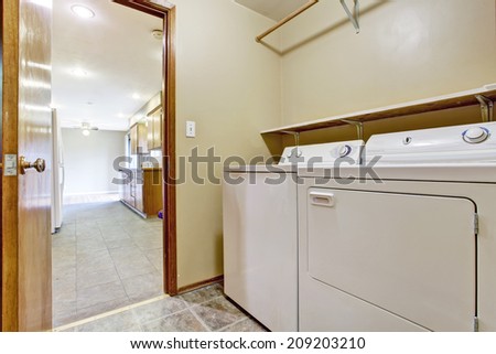 Laundry room with washer and dryer in empty house