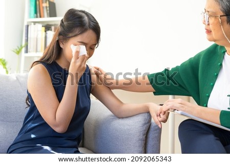 Young Asian woman with depression crying and having consultation session with psychiatrist in mental health service center. Royalty-Free Stock Photo #2092065343