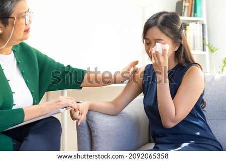 Young Asian woman with depression crying and having consultation session with psychiatrist in mental health service center. Royalty-Free Stock Photo #2092065358