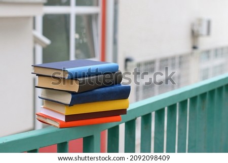 Books on the fence in front of the school