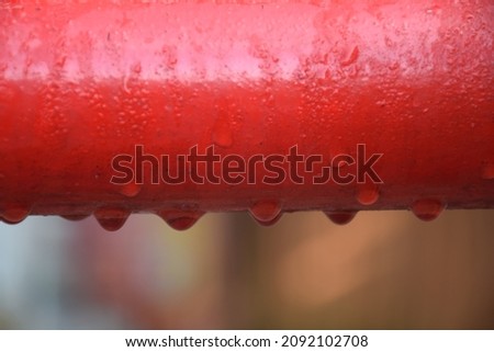 Dew on an orange iron fence, Indonesia 