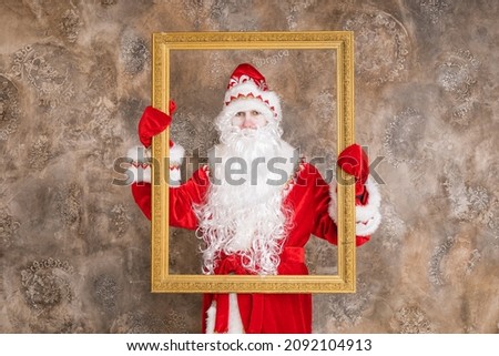 Russian Santa Claus in a beautiful red coat with white fur, a traditional Russian costume, is standing indoors. Christmas, new year, holidays, children's animation, actor. Christmas picture