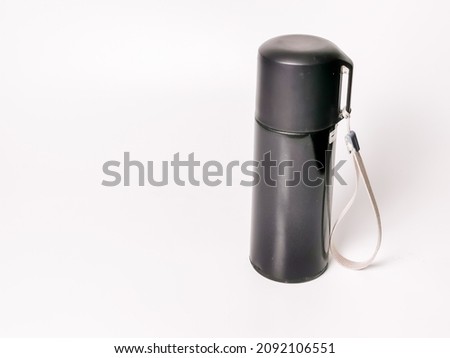 Photo of reusable black steel thermo water bottle against white background. Environment and zero waste concept.
