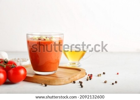 Glass with tasty gazpacho on light background Royalty-Free Stock Photo #2092132600