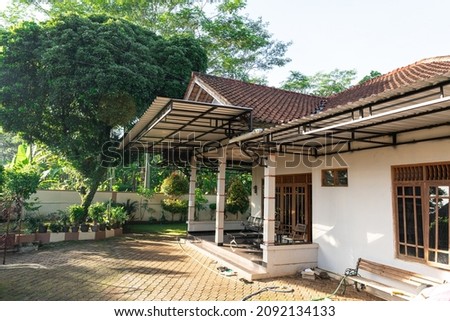 One of the houses in Indonesia with trees and ornamental plant pots. Royalty-Free Stock Photo #2092134133