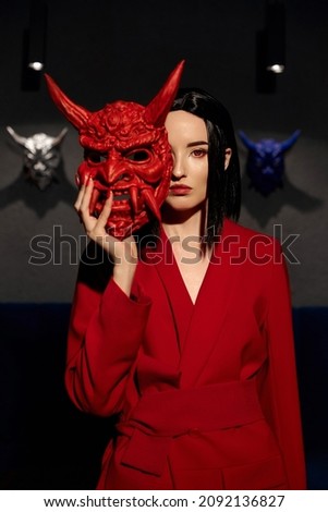 Anime woman in a red suit with short hair cut, black hair. A killer girl in a red jacket with a red Japan mask. Beauty portrait