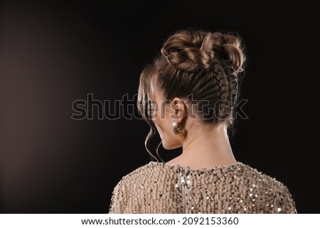 Beautiful young woman with braided hair on dark background Royalty-Free Stock Photo #2092153360