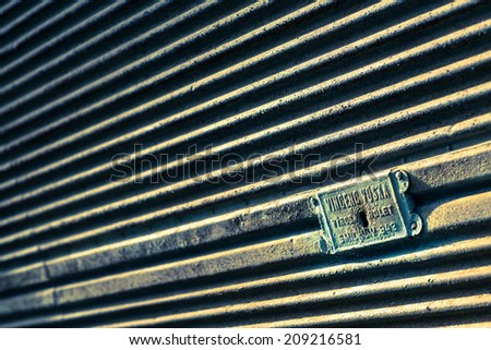 Old rusted metal door. Vintage filter. Selective focus.