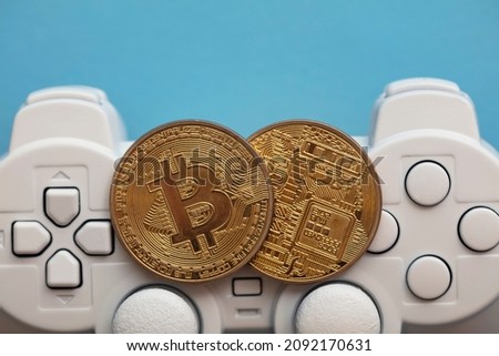 Crypto gaming concept. Video game controller with a bitcoin cryptocurrency coin Royalty-Free Stock Photo #2092170631