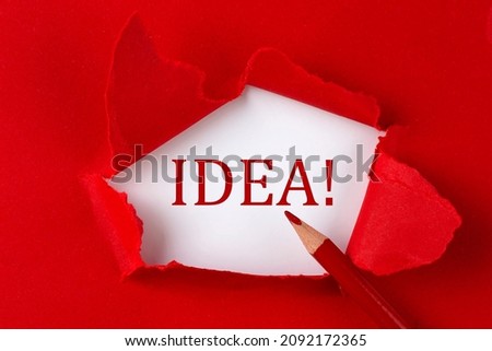 IDEA text on red torn paper with red pencil