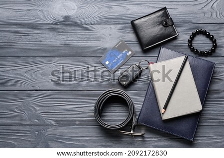 Set of stylish male accessories on dark wooden background