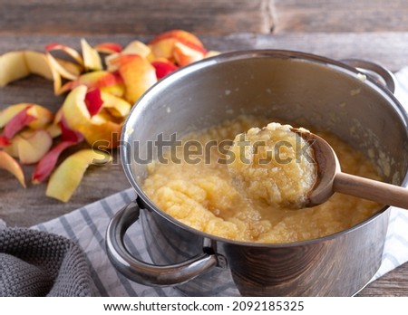 Homemade applesauce in a pot with wooden spoon Royalty-Free Stock Photo #2092185325