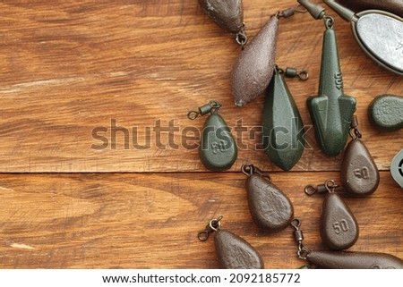 Heap of lead weights for fishing on wooden background Royalty-Free Stock Photo #2092185772