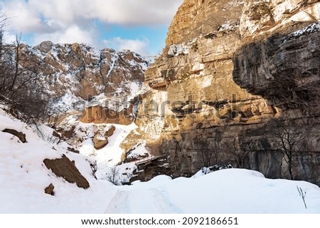 Narrow snowy road in a mountain gorge