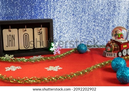New Year's background and January 1st on the calendar, next to it there are decorative elements for decorating the house.