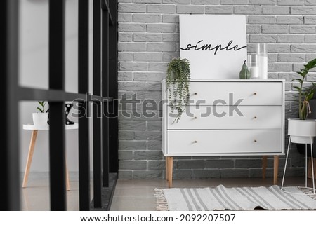 Modern chest of drawers in interior of living room