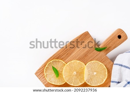 Lemon slices on a wooden board on a white background. Organic citrus fruits for a healthy diet. Beautiful fresh Flat lay. Top view.